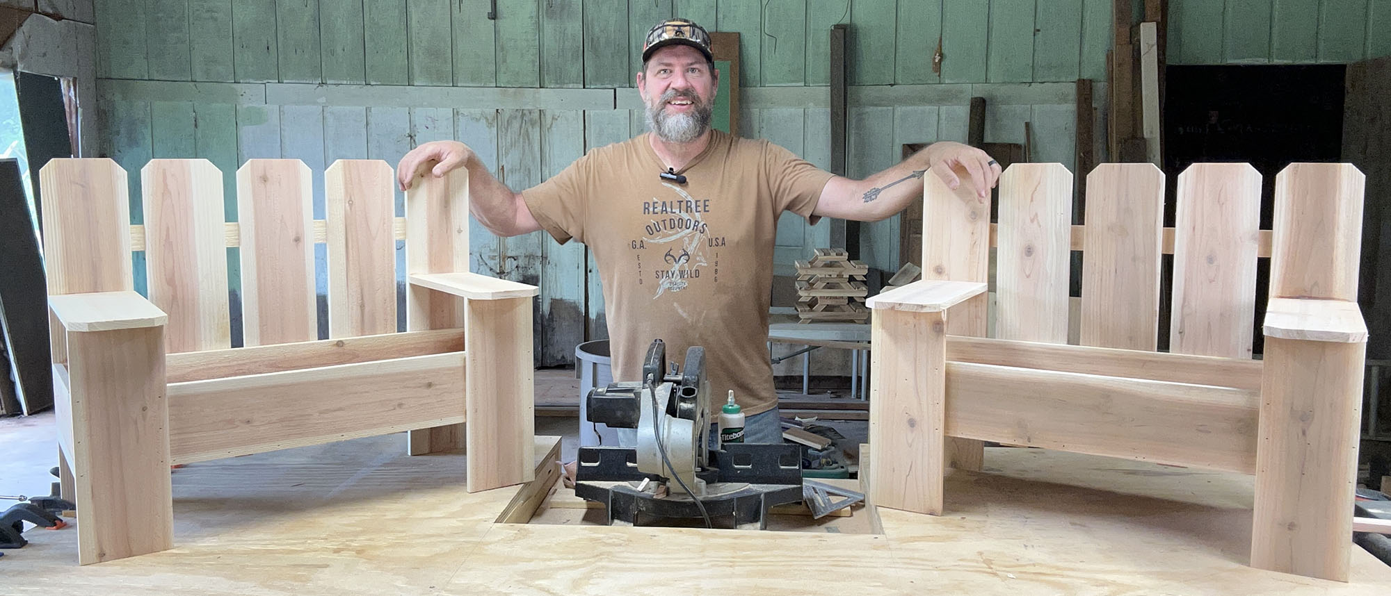 Brian Grossman standing next to two garden bench planter boxes.