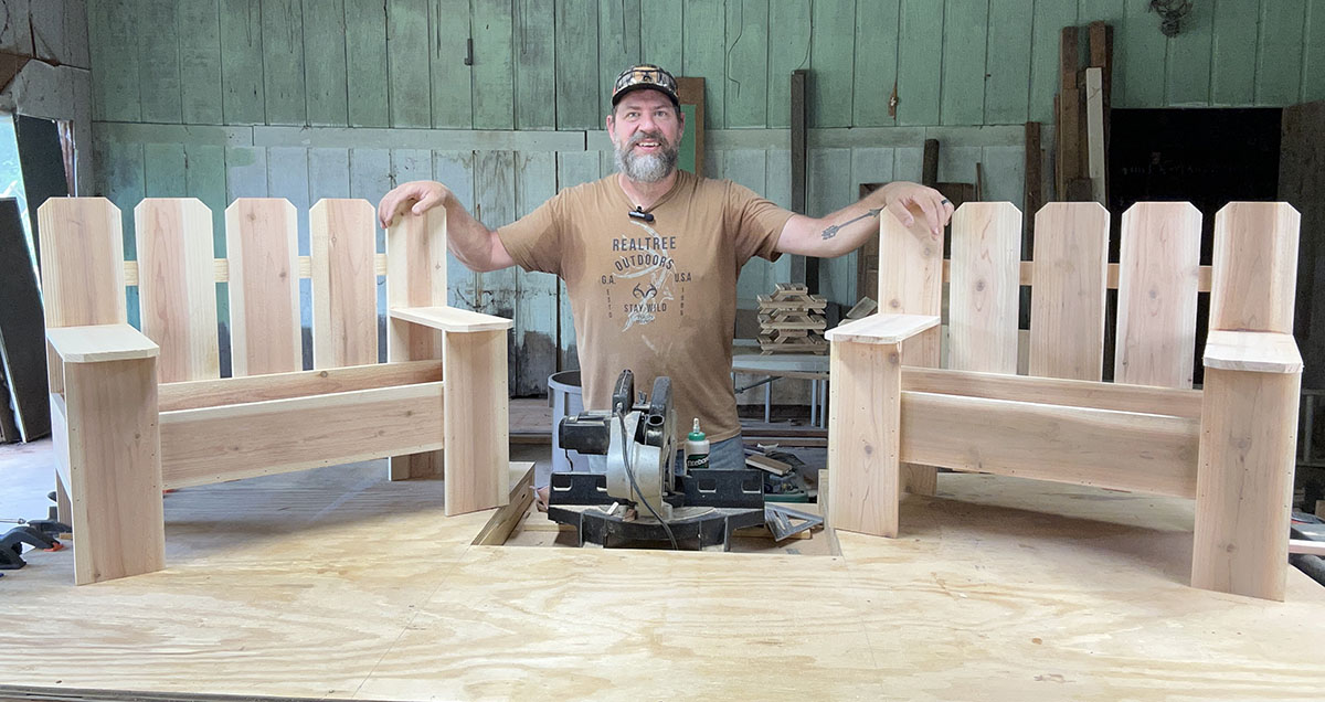 Brian Grossman standing next to two garden bench planter boxes.
